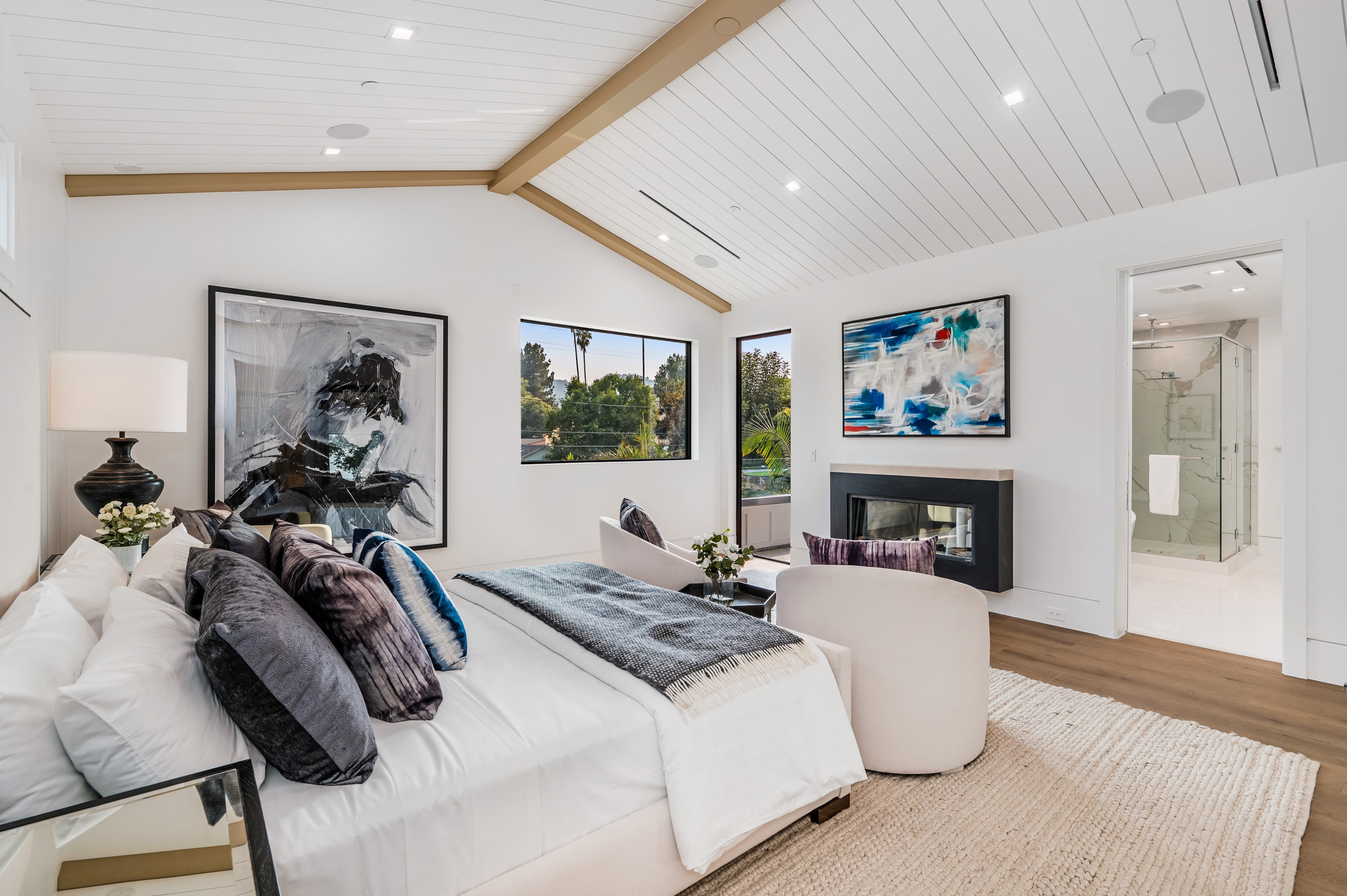 Master bedroom with vaulted ceiling and fireplace