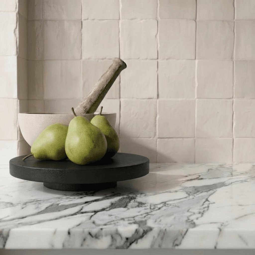 Arabescato marble benchtop with handmade Zellige tiles and a bowl of pears — considered material selection for a North Shore interior Arabescato marble benchtop with handmade Zellige tiles and a bowl of pears — considered material selection for a North Shore interior