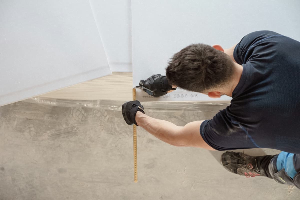 Tradesperson measuring during a pre-sale repair managed by Styling Lab