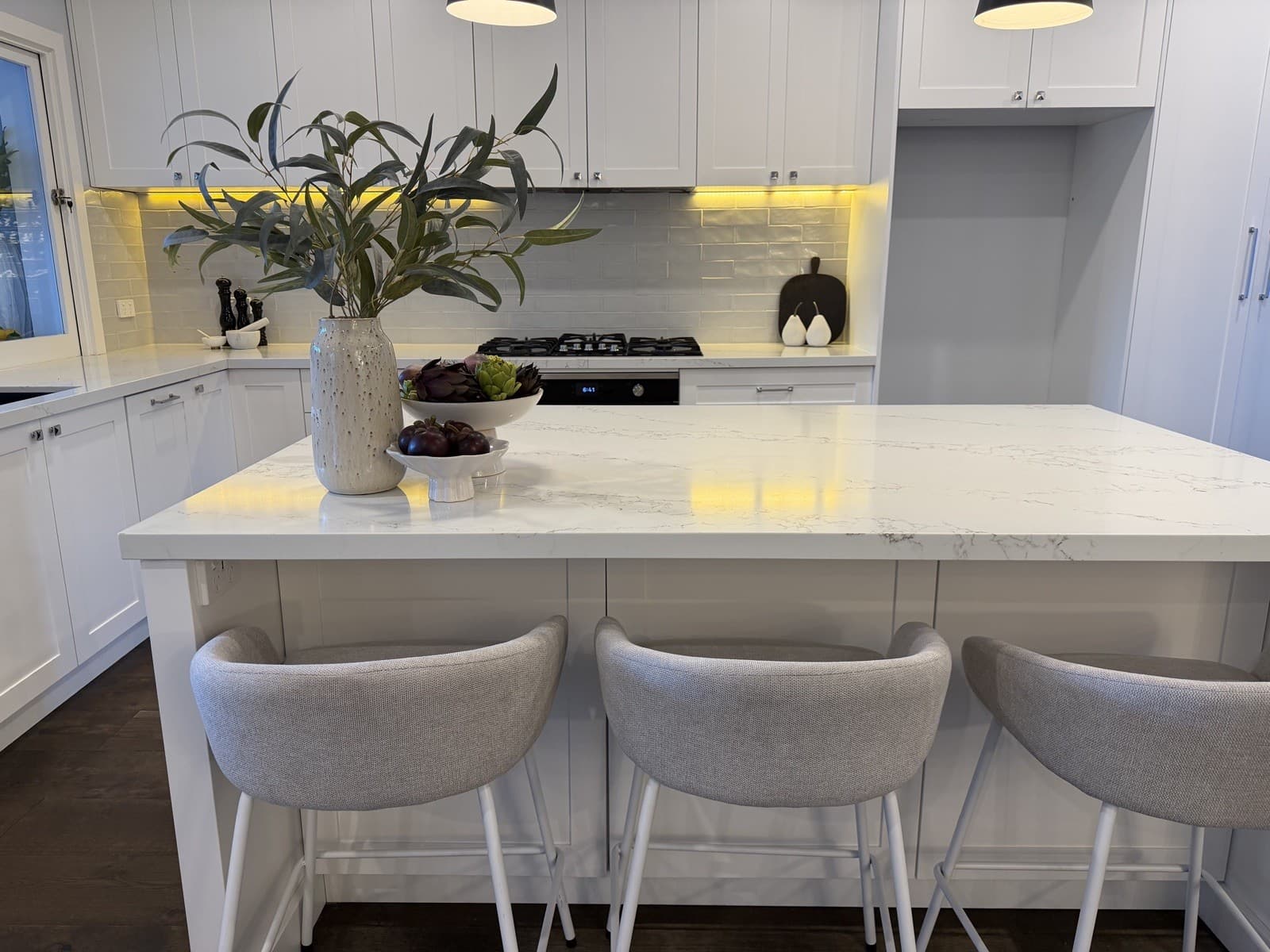 Kitchen island styled with grey bar stools and marble benchtop — property styling North Shore Sydney