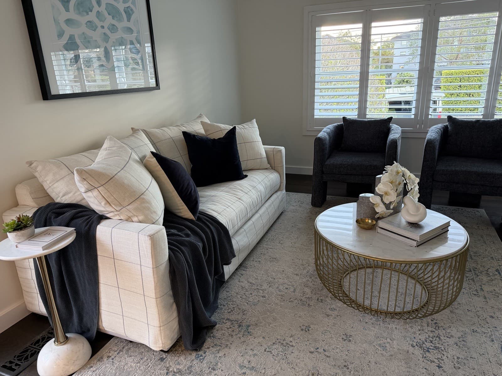 Living room styled with marble coffee table and orchid — property styling North Shore Sydney
