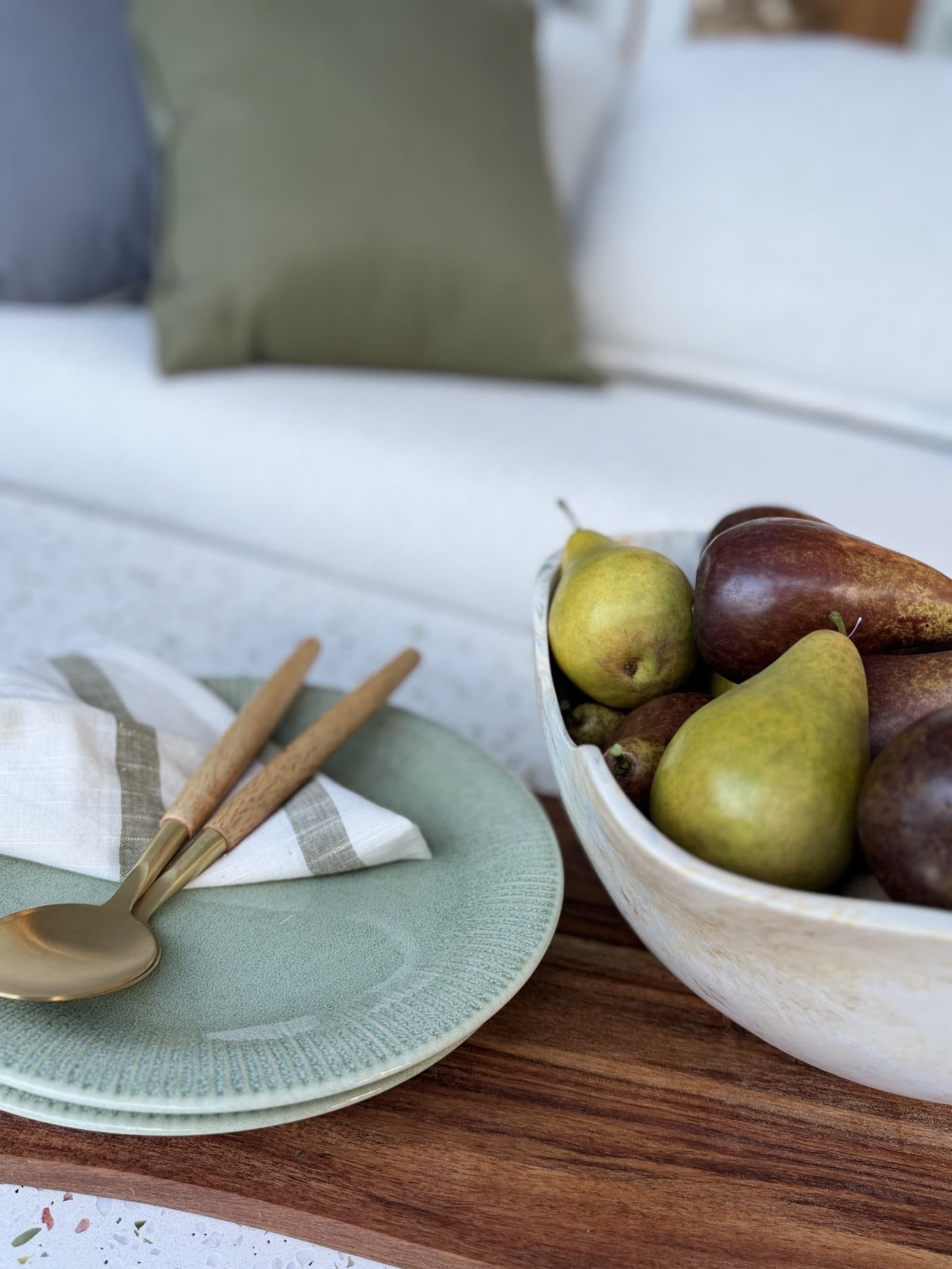 Dining tablescape with green plate and pears — property styling North Shore Sydney